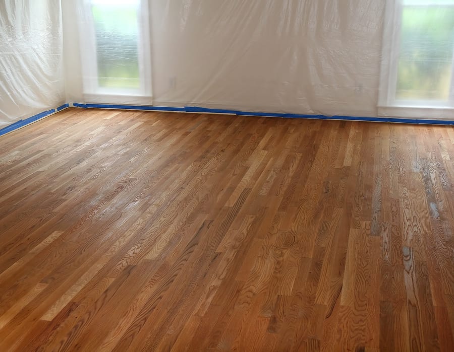 A room with hardwood floors being refinished.
